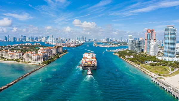 Cargo ship in the water in the middle of a city 