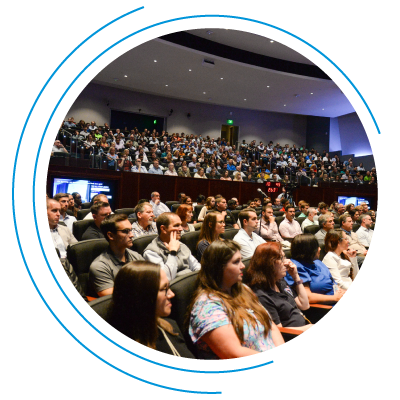 Diverse crowd enjoying a conference presentation Diverse crowd enjoying a conference presentation