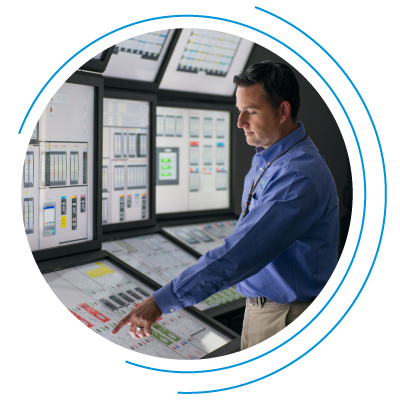 Man standing in front of multi-panel monitor Man standing in front of multi-panel monitor