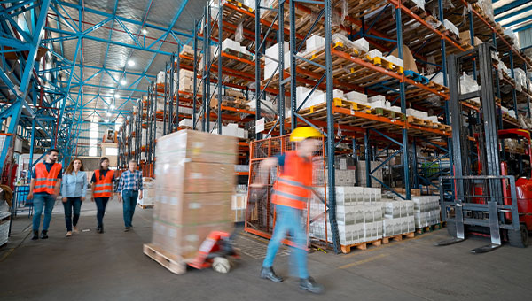 Employees move goods through a distribution warehouse in Florida.