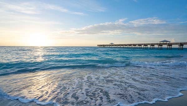 View of the ocean and pier at sunrise