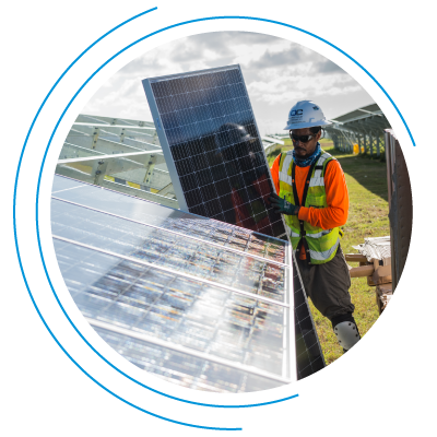 A man works to install solar panels into a large array A man works to install solar panels into a large array