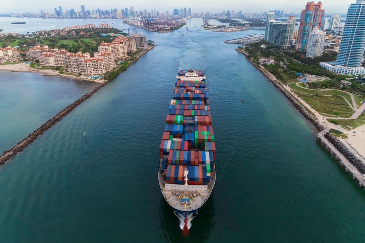 Ariel view of a large cargo ship moving through the Port of Miami